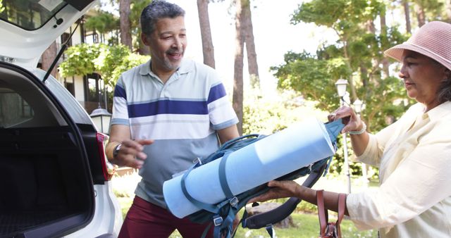 Senior Couple Preparing For Camping Trip With Backpack And Yoga Mat - Download Free Stock Images Pikwizard.com