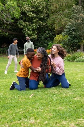 Multigenerational Family Enjoying Day in Park Surrounded by Nature