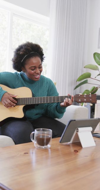 Young Woman Playing Acoustic Guitar and Smiling at Home - Download Free Stock Images Pikwizard.com