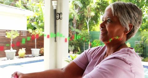 Senior woman stretching on backyard patio with candlestick trading overlay for wellness