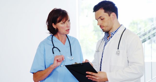 Focused Doctors Discussing Patient Medical Records - Download Free Stock Images Pikwizard.com