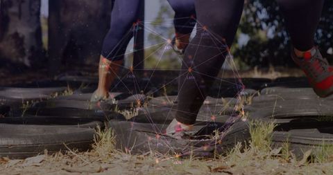 Athletes stepping through tire zone with augmented reality overlay