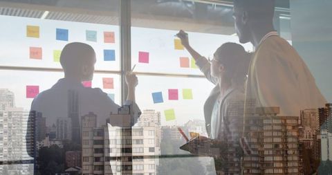 Diverse Coworkers Brainstorm Solutions with Sticky Notes in Office