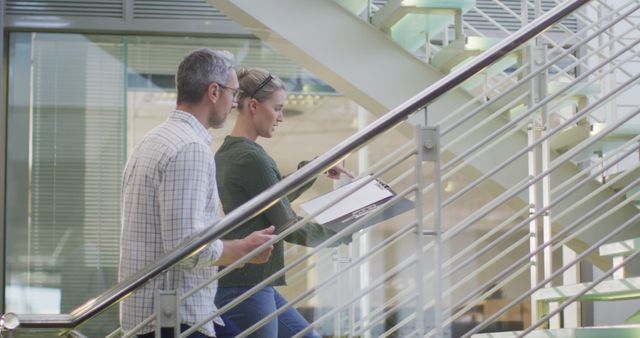 Two Professionals Discussing Work on Staircase in Modern Office - Download Free Stock Images Pikwizard.com