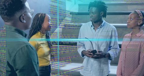 Young professionals collaborating around augmented holographic code overlay on stairs