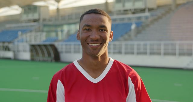 Confident Young Soccer Player Smiling on Field - Download Free Stock Images Pikwizard.com