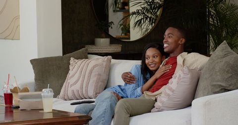 Couple Relaxing on Sofa Enjoying Intimate Moments Together