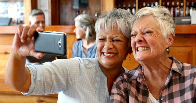 Cheerful Senior Women Taking Selfie in Café - Download Free Stock Images Pikwizard.com