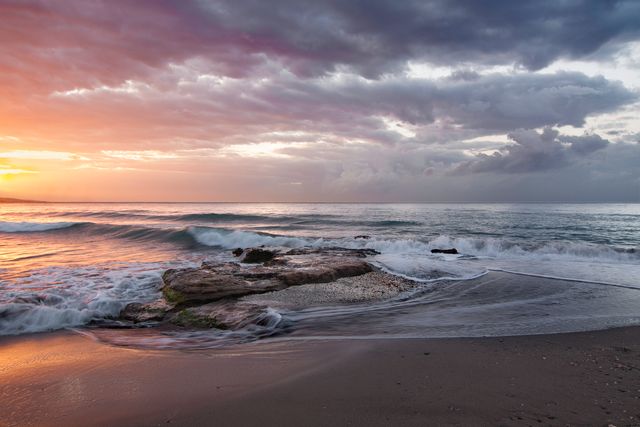 Vivid Sunset Over Rocky Ocean Shoreline with Waves Crashing - Download Free Stock Photos Pikwizard.com