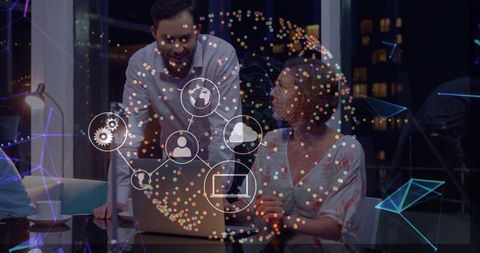 Collaborative team brainstorming with holographic network overlay in modern office at night