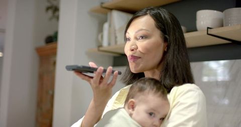 Modern Mother Balancing Work and Parenthood in Cozy Kitchen