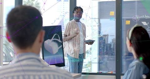 Presenting vr prototype to team in modern office with glass board and urban view