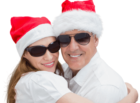 Smiling Couple in Santa Hats Embracing Isolated on Clear Background