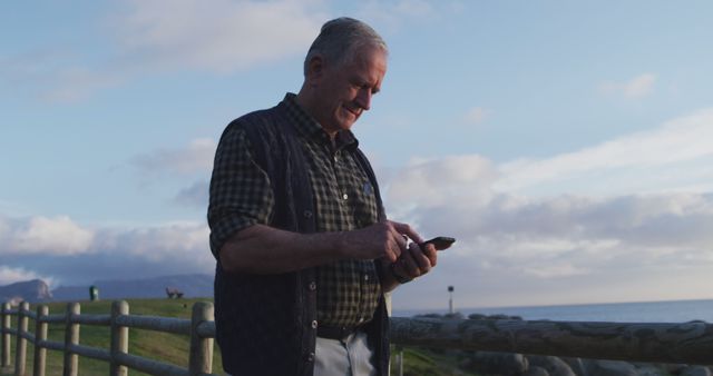 Senior Man Using Smartphone Outdoors at Sunset - Download Free Stock Images Pikwizard.com