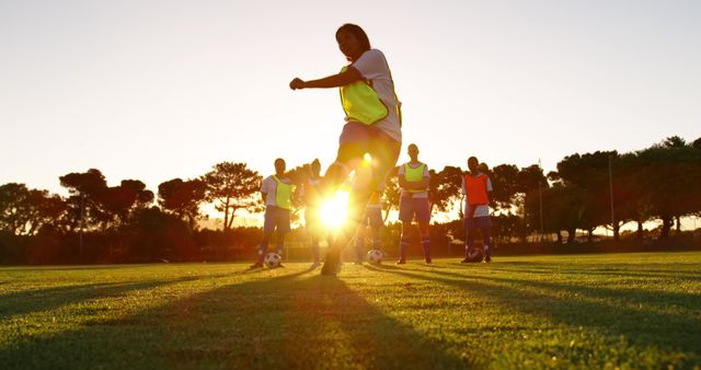 Soccer Team Training at Sunset on Grass Field - Download Free Stock Images Pikwizard.com