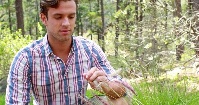 Man Exploring Nature in Forest, Examining Plants on Leisure Day - Download Free Stock Images Pikwizard.com