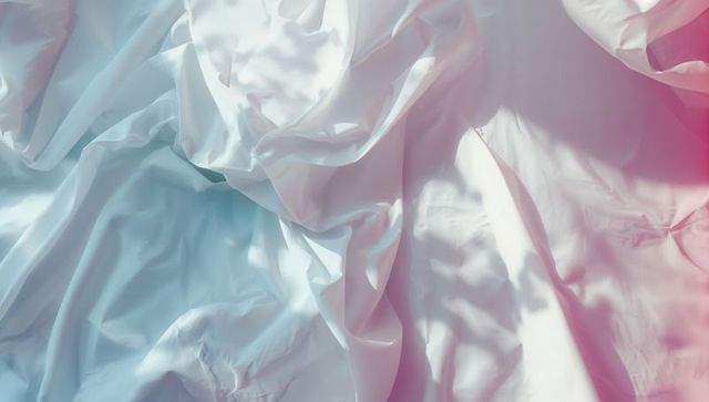 Crumpled white fabric with blue to pink gradient lighting
