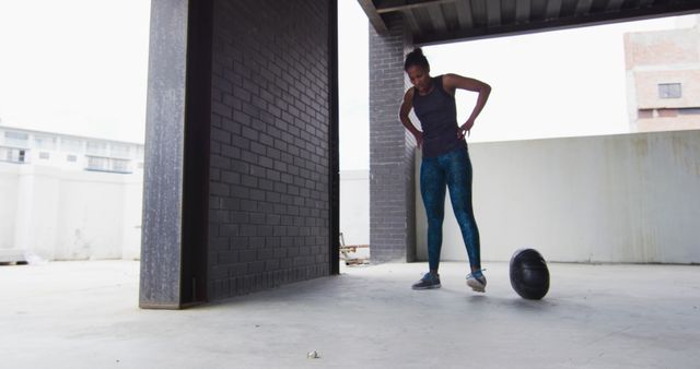 Woman Resting After Intense Workout, Standing by Medicine Ball in Urban Gym - Download Free Stock Images Pikwizard.com