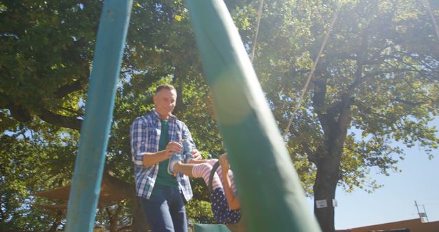 Father Pushing Child on Swing in Sunny Park - Download Free Stock Images Pikwizard.com