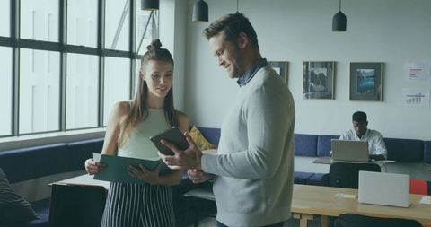 Collaborative Coworkers Discussing Project in Modern Office
