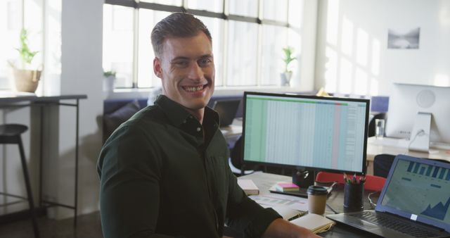 Portrait of happy caucasian businessman looking at camera at office. Work at a modern office.