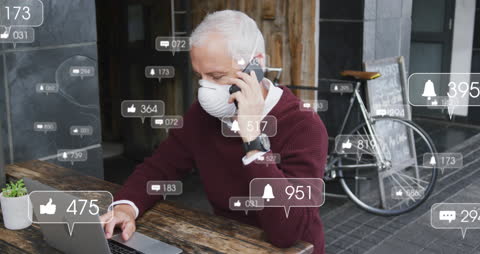 Senior Man Engaging with Social Media on Mobile and Laptop