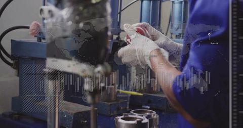 Technician assembling precision metal parts on industrial press with digital data overlay
