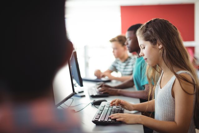 Students using computer in classroom at school