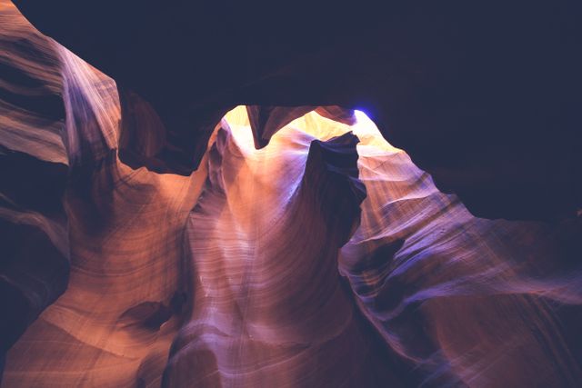 Sunlight beams illuminate sandstone formations within Antelope Canyon, Arizona. Ideal for use in travel brochures, geological studies, nature magazines, and adventure-themed marketing materials.