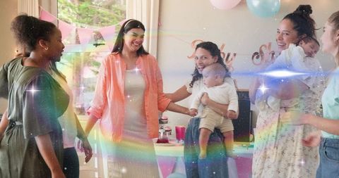Smiling pregnant woman celebrating baby shower with friends, pastel balloons and decor
