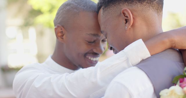 Happy diverse gay male couple embracing outdoors in the sun - Download Free Stock Photos Pikwizard.com