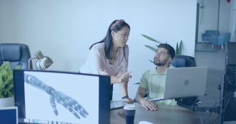 Colleagues Collaborating on Futuristic Technology Project