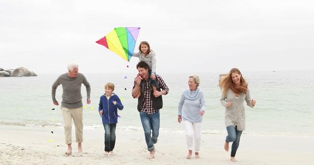 Happy Multigenerational Family Flying Kite on Beach - Download Free Stock Images Pikwizard.com