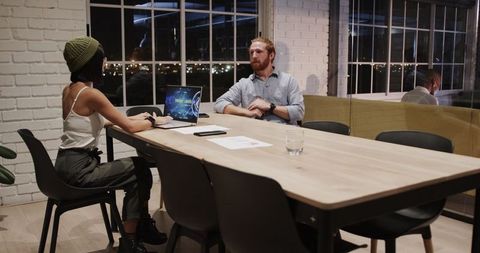 Night Office Meeting with Colleagues Collaborating on Project