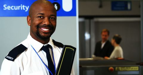 Friendly security officer at airport terminal