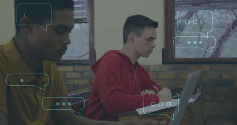 Students studying with laptop and notebooks focusing on writing and note-taking