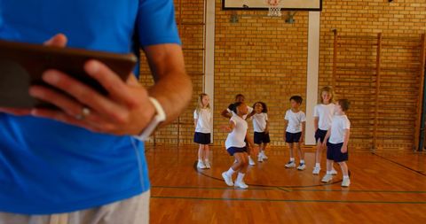 Basketball Coach and Students with Digital Tablet in Gymnasium - Download Free Stock Images Pikwizard.com