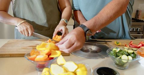 Senior Couple Preparing Vegetables Together in Kitchen