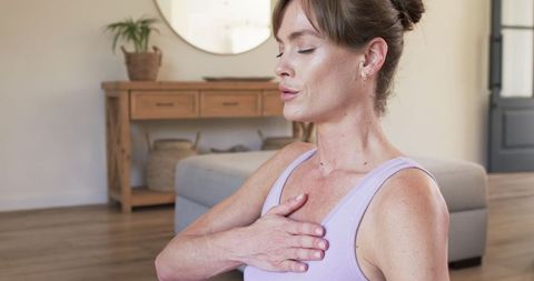 Middle-Aged Woman Practicing Yoga Meditation at Home in Serene Environment