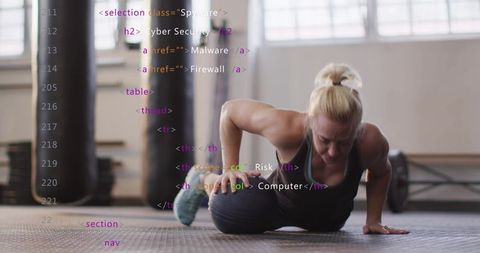 Woman balancing on medicine ball while training core strength and stability in gym