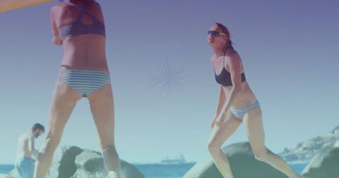 Women Enjoying Beach Volleyball in Sunny Weather