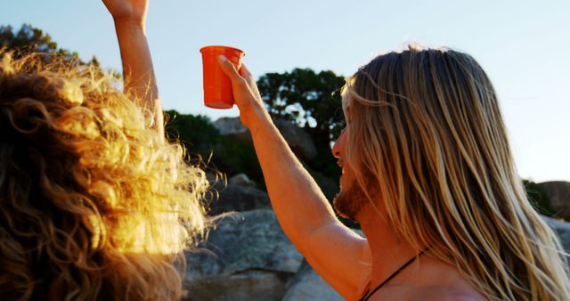 Happy Young Adults Celebrating Outdoors with Drinks - Download Free Stock Images Pikwizard.com