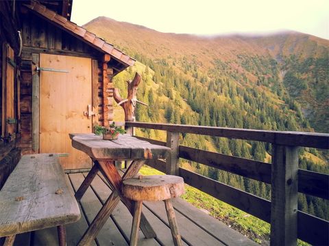 Rustic Cabin Balcony Overlooking Forested Mountain