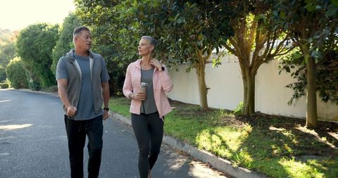 Senior Couple Enjoying Outdoor Walk in Suburban Neighborhood