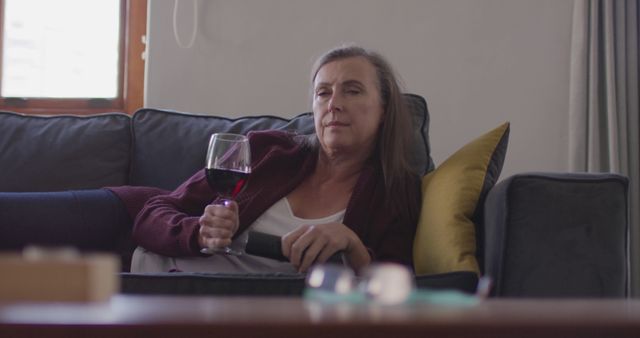 Senior Woman Relaxing on Couch with Glass of Wine and Remote - Download Free Stock Images Pikwizard.com