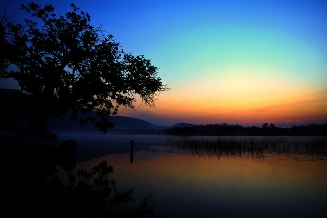 Serene Lake Sunrise with Reflective Water Landscape - Download Free Stock Photos Pikwizard.com