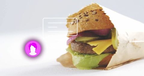 Half-wrapped burger with vibrant icon and ui overlay