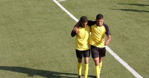 Young Soccer Players Practicing Teambuilding on Field