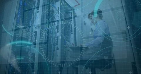 Network Technician Inspecting Data Center Equipment with Laptop