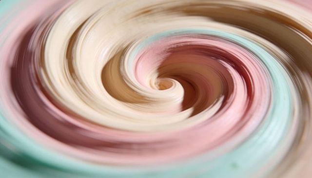 Swirling pastel cream vortex spiraling mint pink beige macro abstract background soft